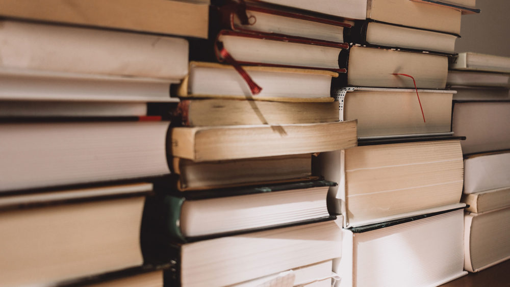 three vertical stacks of books