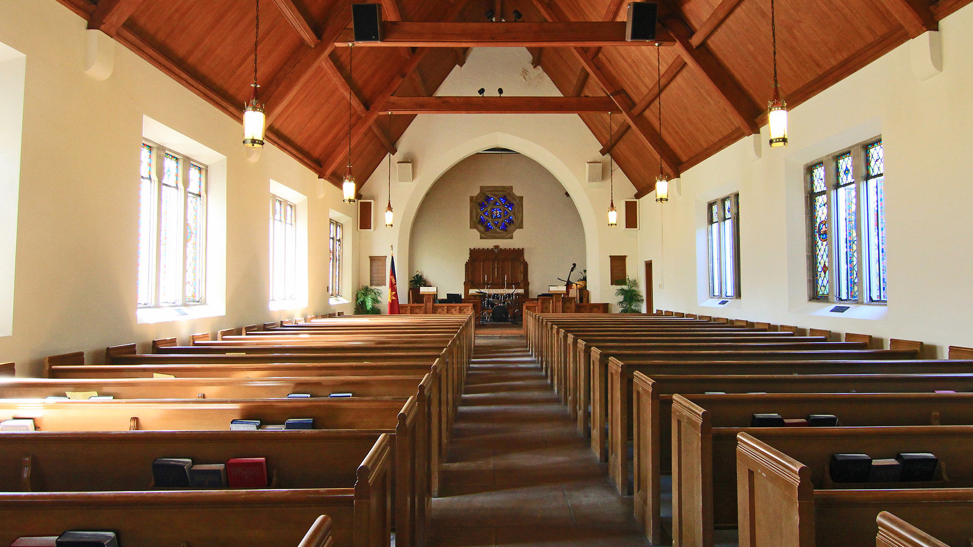 the inside of a church with rows of pews on either side