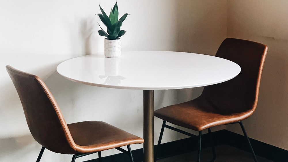 two chairs around a white circular table
